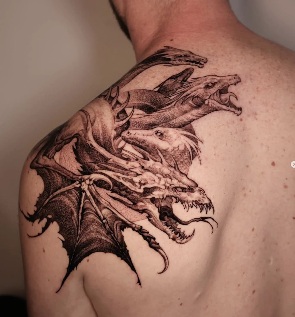 Multi-headed dragon on shoulder blade