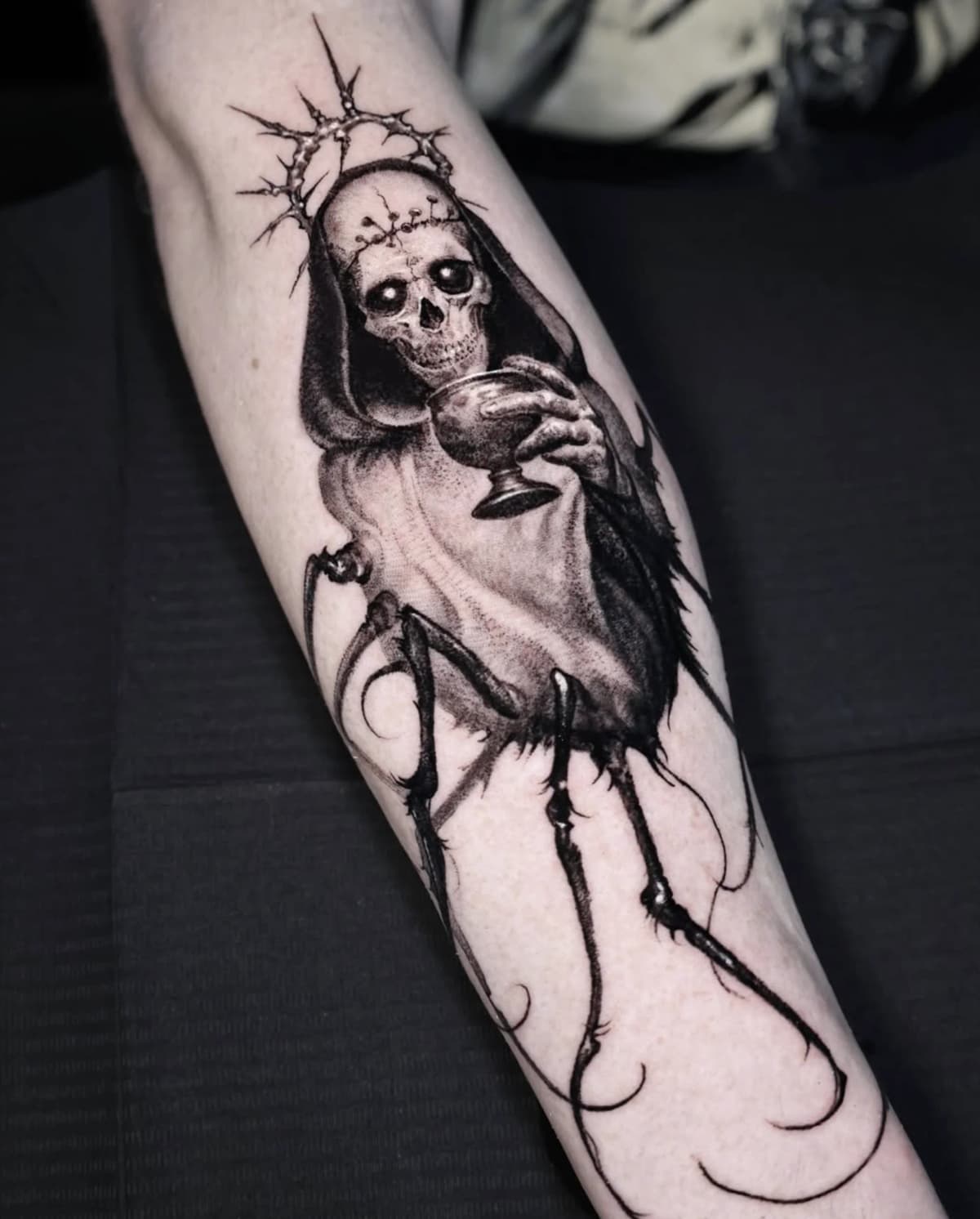 Skeletal saint with chalice and thorn crown